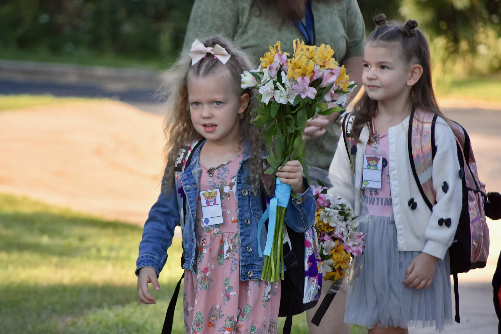 Two students arrive at school with bouquets of flowers for the teachers