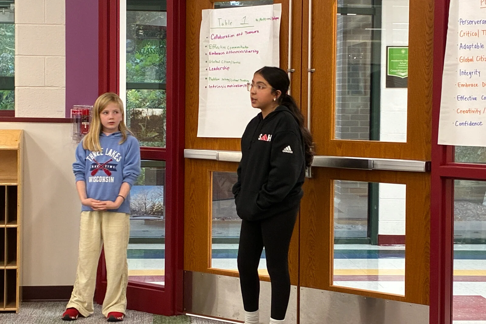 Portrait or a Learner meeting 2 - two female students present to the committee at Meadowview School