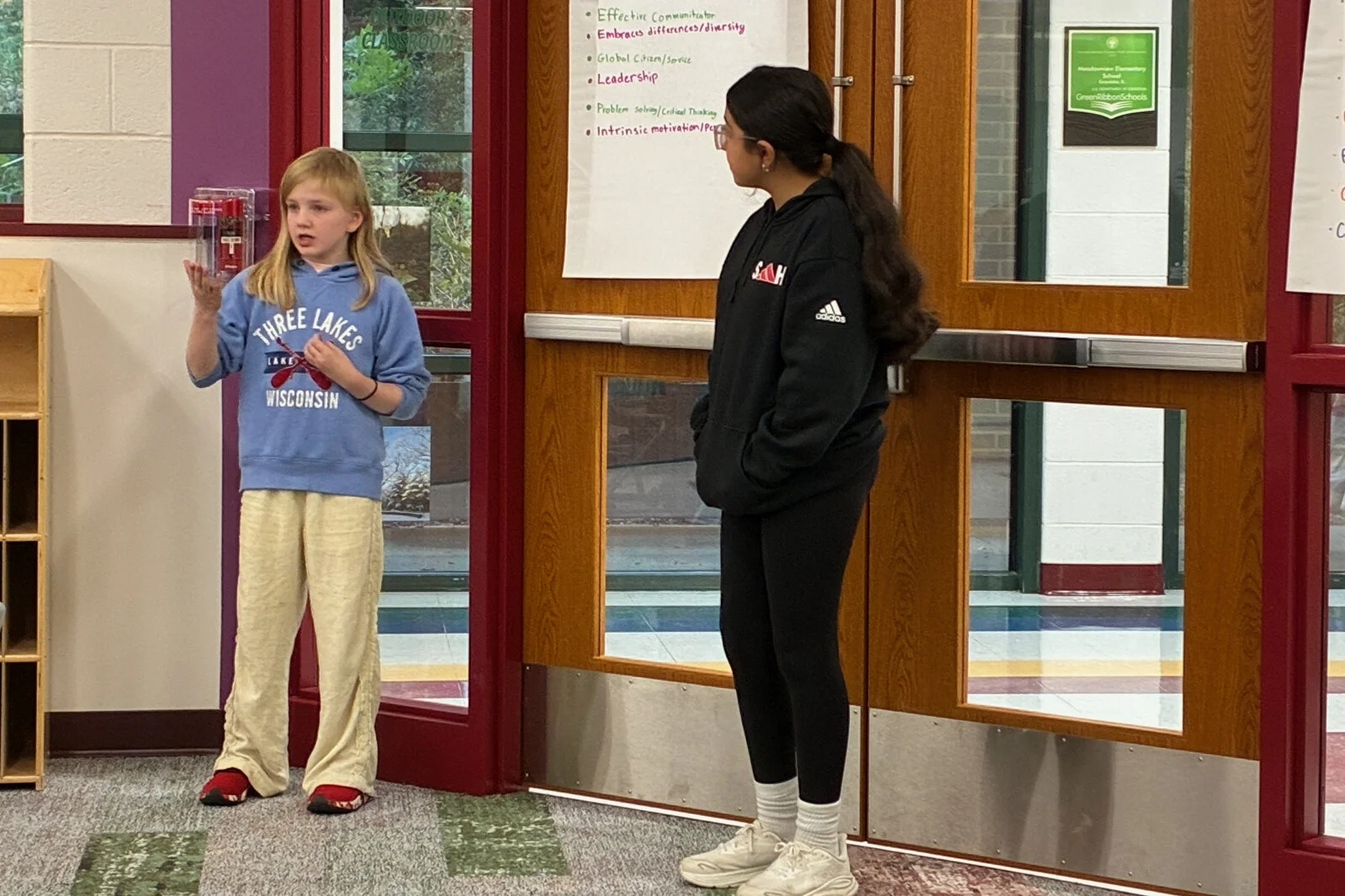 Portrait or a Learner meeting 2 - two female students present to the committee at Meadowview School