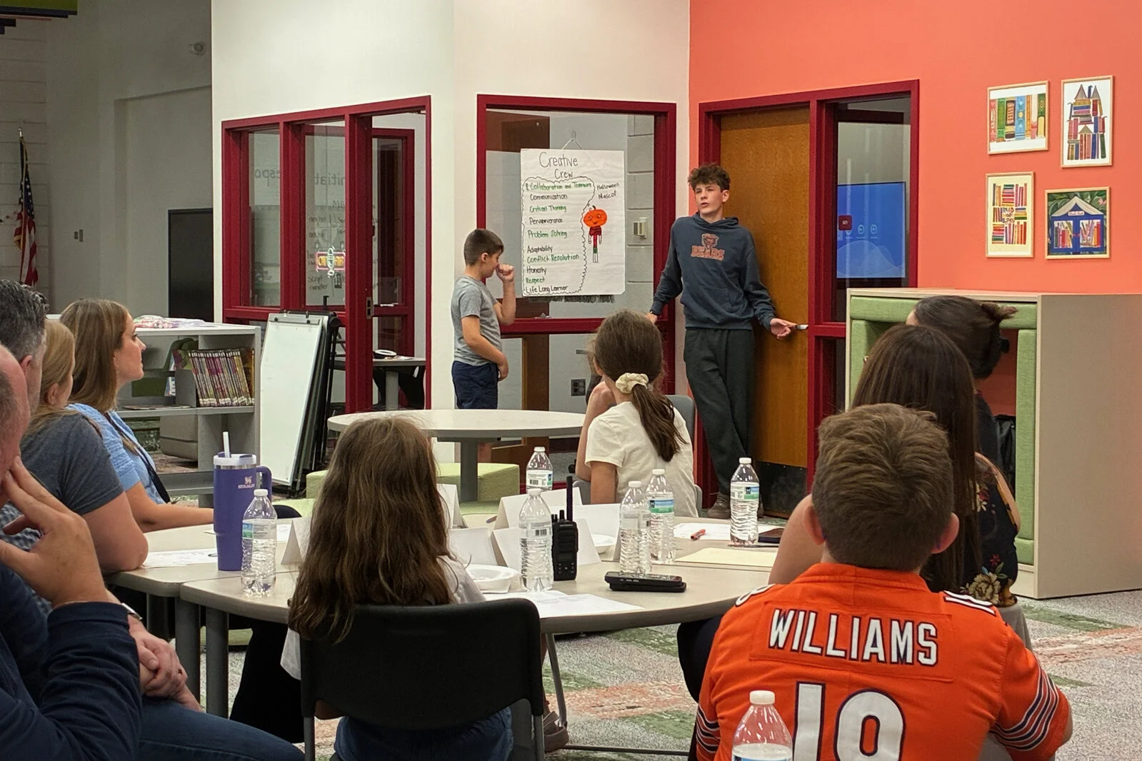 Portrait or a Learner meeting 2 - 2 male students present to the committee at Meadowview School